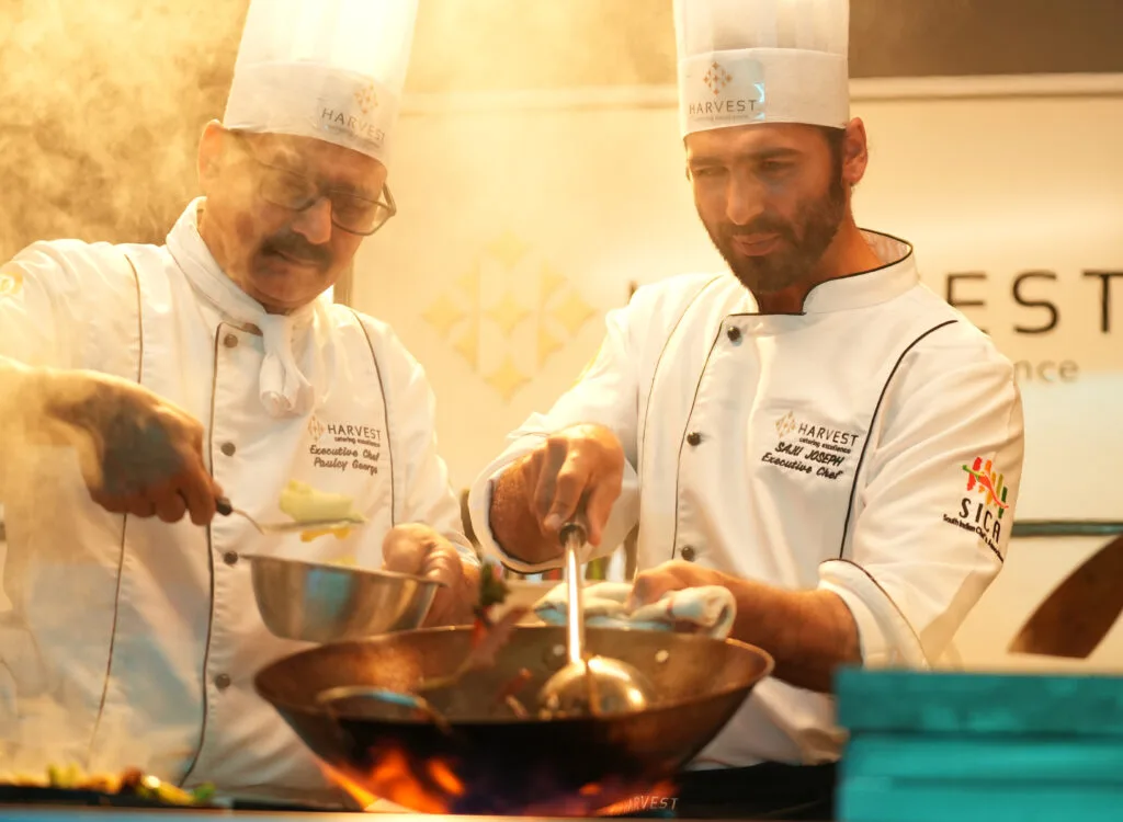 Harvest Caterers executive chefs in Kochi showcasing live cooking for wedding and corporate catering.