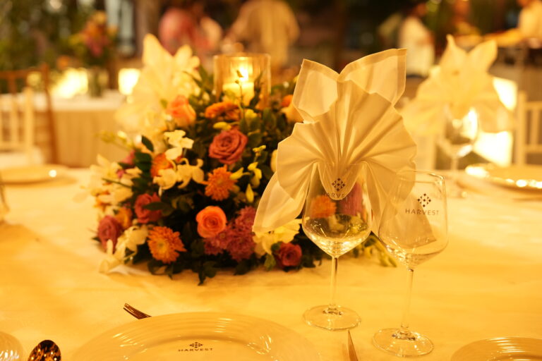 Elegant wedding table setup with floral centerpiece, folded napkins, and premium glassware, showcasing wedding catering in Kochi.