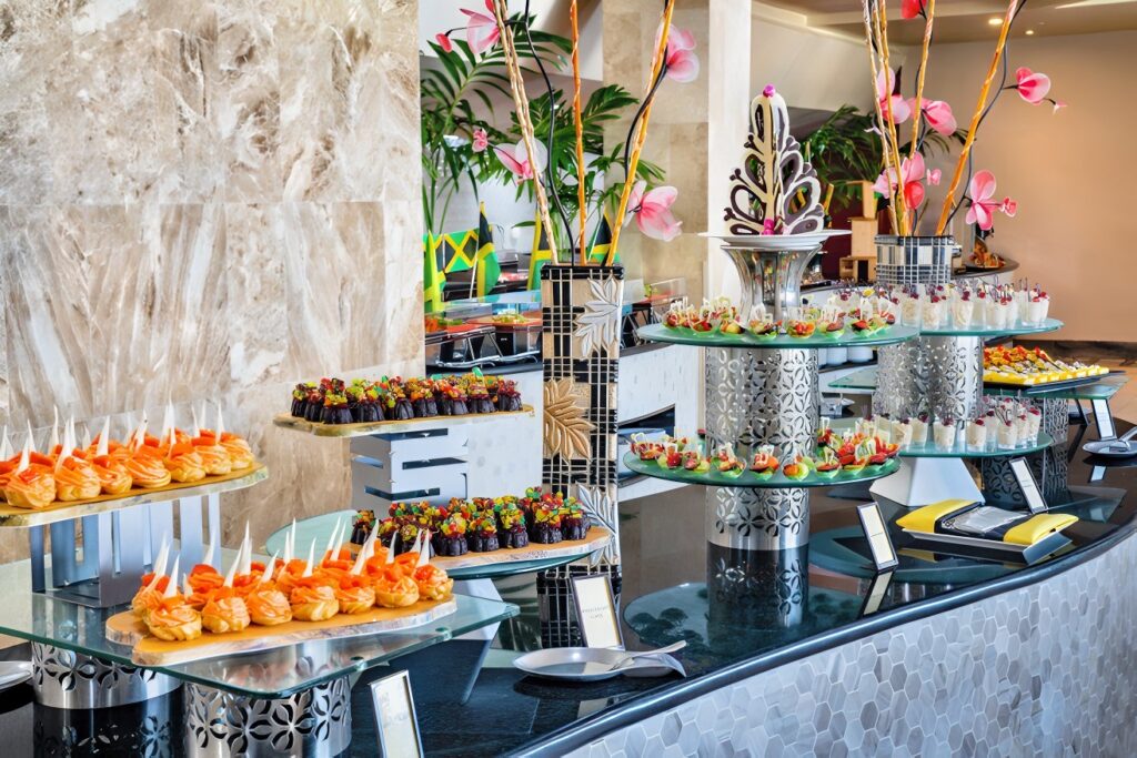 A premium buffet-style dessert setup featuring diverse global treats and presentation styles, highlighting a thoughtfully planned multicultural wedding menu.