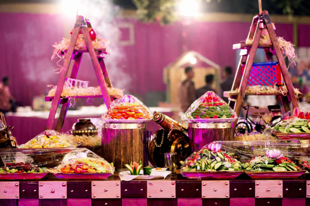 A vibrant live food counter displaying salads and starters with elegant décor, showcasing the variety included in wedding catering packages in Kerala.