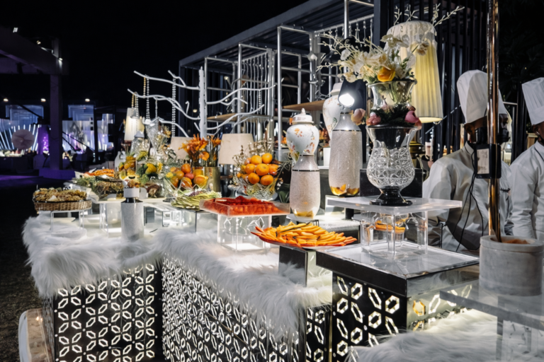 A luxury catering display with live food stations, decorative presentation, and trained staff, offering insight into how to choose a caterer in Kerala.