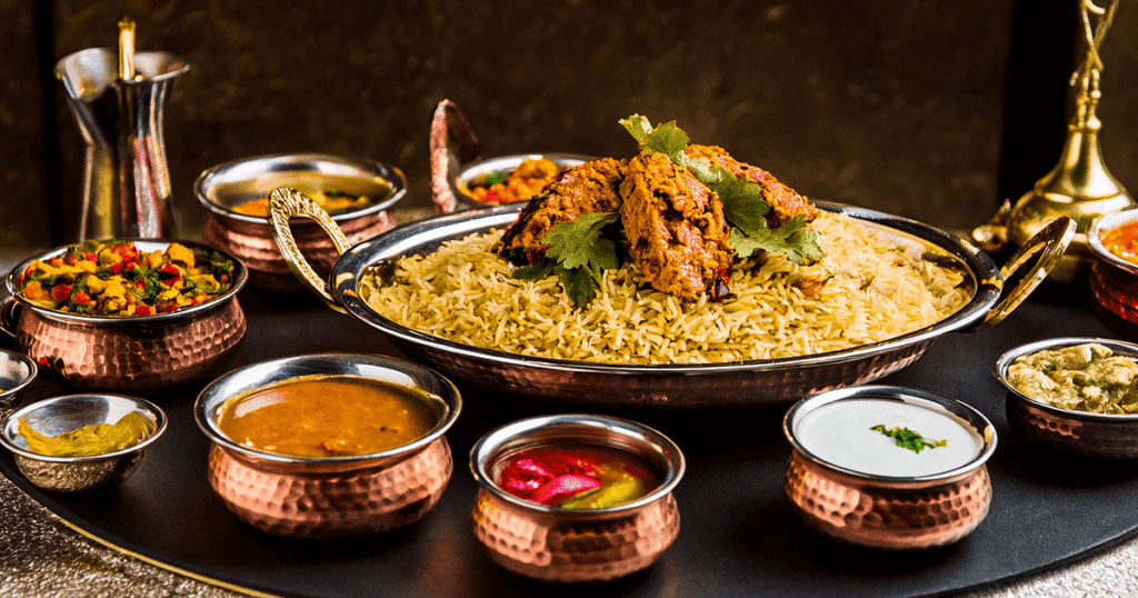 A royal-style wedding food spread featuring biryani, curries, and traditional sides, highlighting authentic wedding catering services in Kerala.