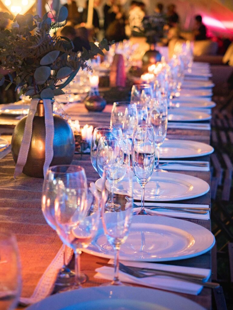 Luxury evening wedding table décor with glassware, candles, and refined plating, highlighting premium wedding caterers in Kerala.